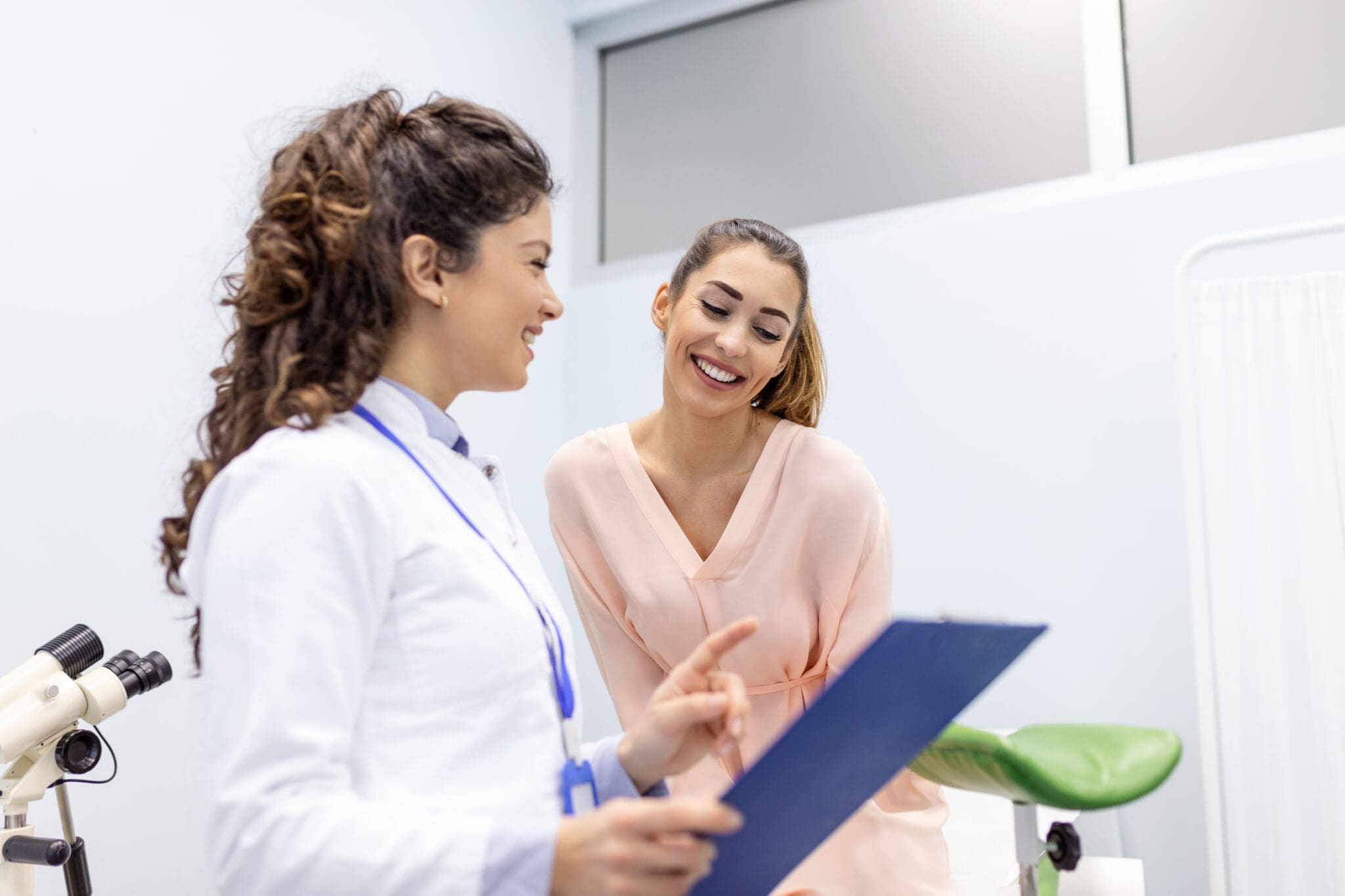 Doctor and patient reviewing medical chart.