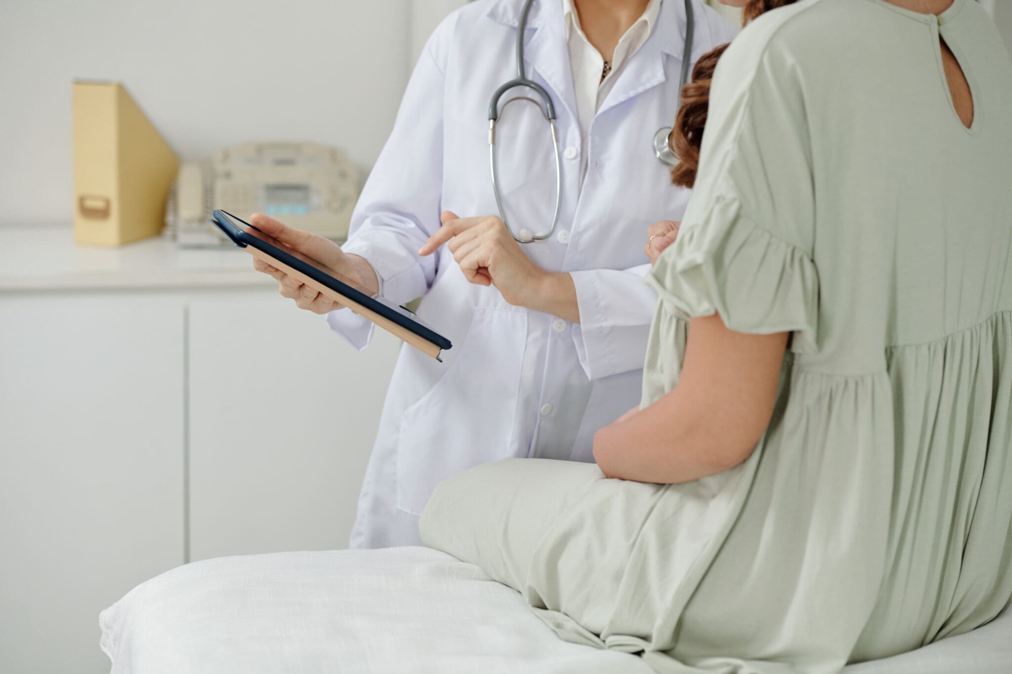 Doctor showing patient tablet results.