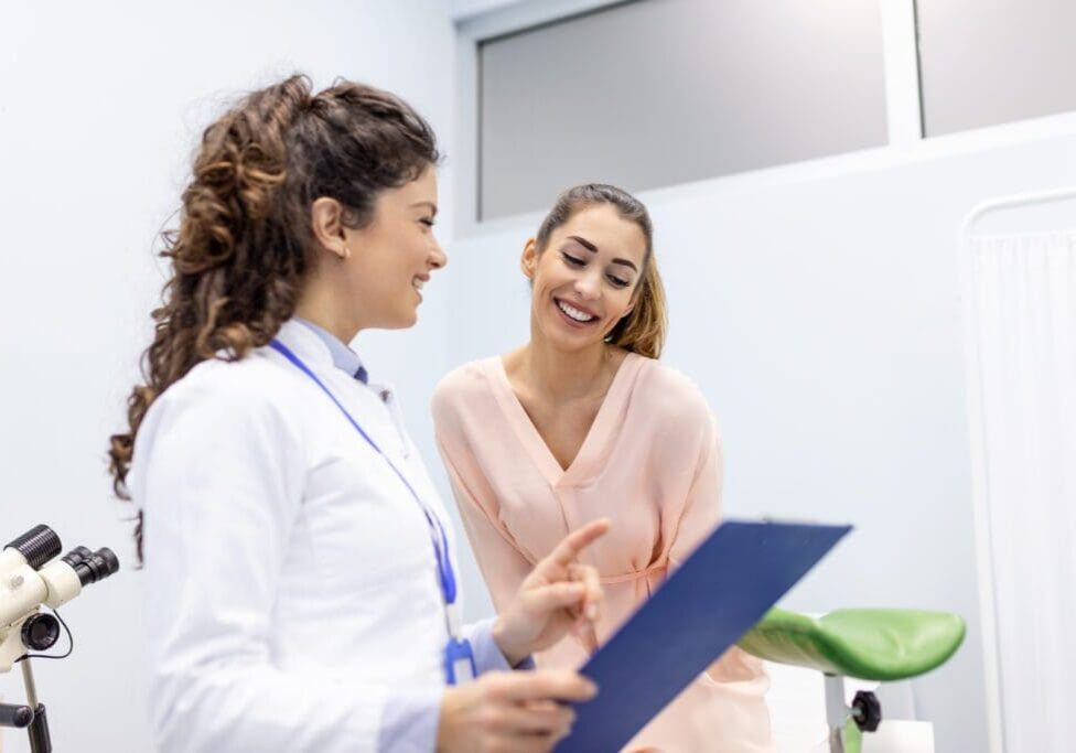 Doctor and patient reviewing medical chart.